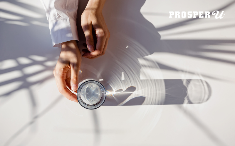 Person holding a cup of water.